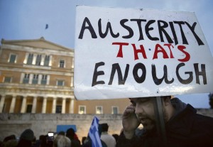 A protester displays his sign during an anti-austerity, pro-government demonstration outside the Greek parliament in Athens